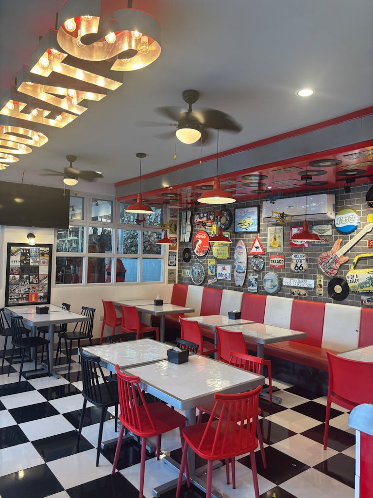 A retro diner interior showcasing vintage decor, red and white seating, and classic ambiance.
